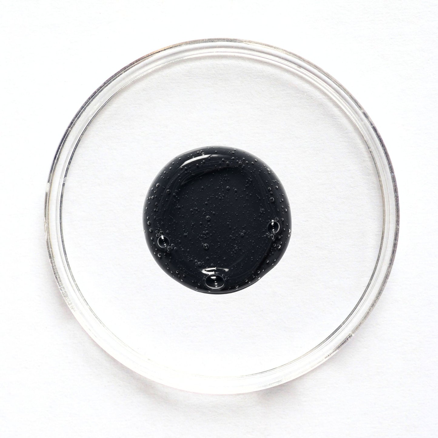 Feliks face cleanser sample in a glass petri dish on a white background