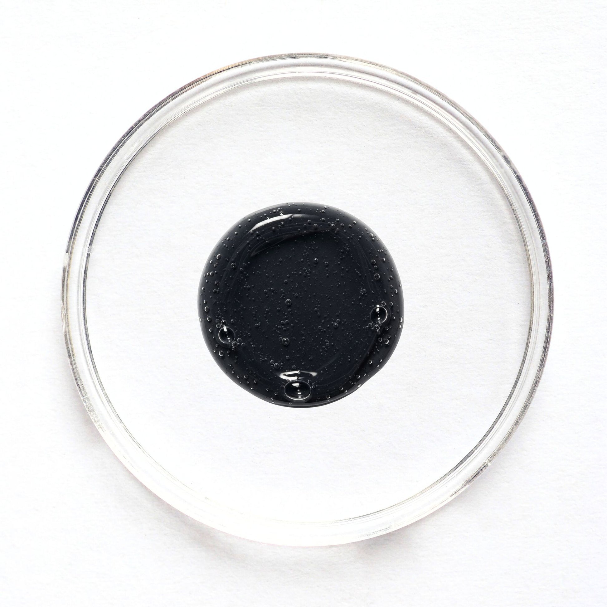 Feliks face cleanser sample in a glass petri dish on a white background
