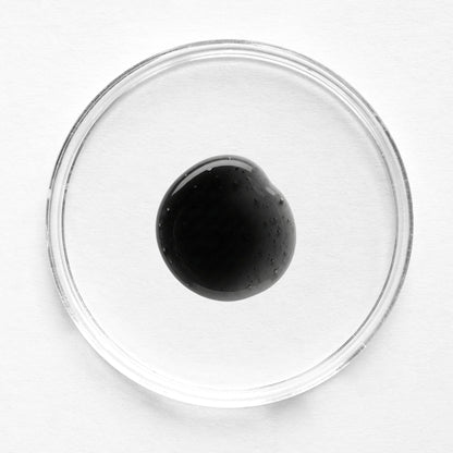 Feliks renewal exfoliator in a glass petri dish on a white background
